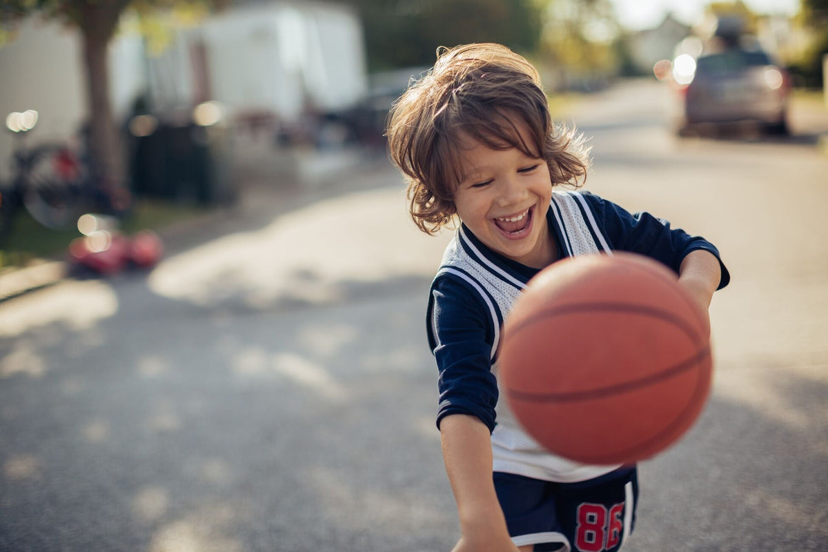 kid playing with a basketball