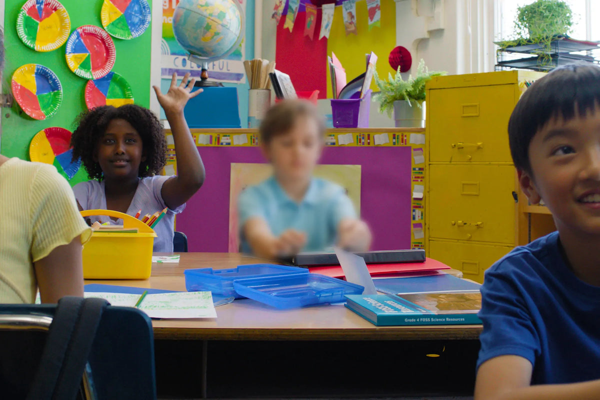 kids in a classroom and one of them is blurred out