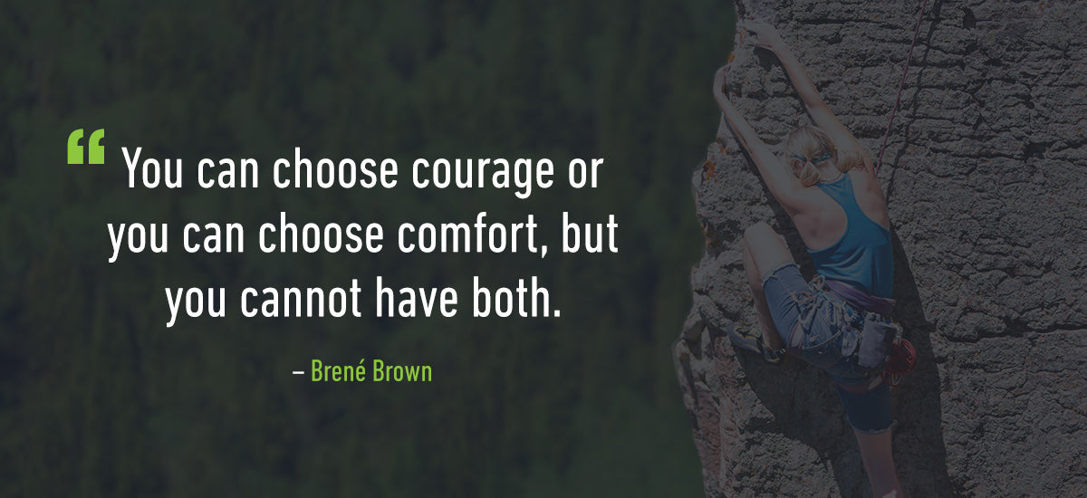 A person wearing a harness and climbing gear scales a rock face with a forest blurred in the background. A quote is overlaid on the image: "You can choose courage or you can choose comfort, but you cannot have both." ‚Äì Bren√© Brown.