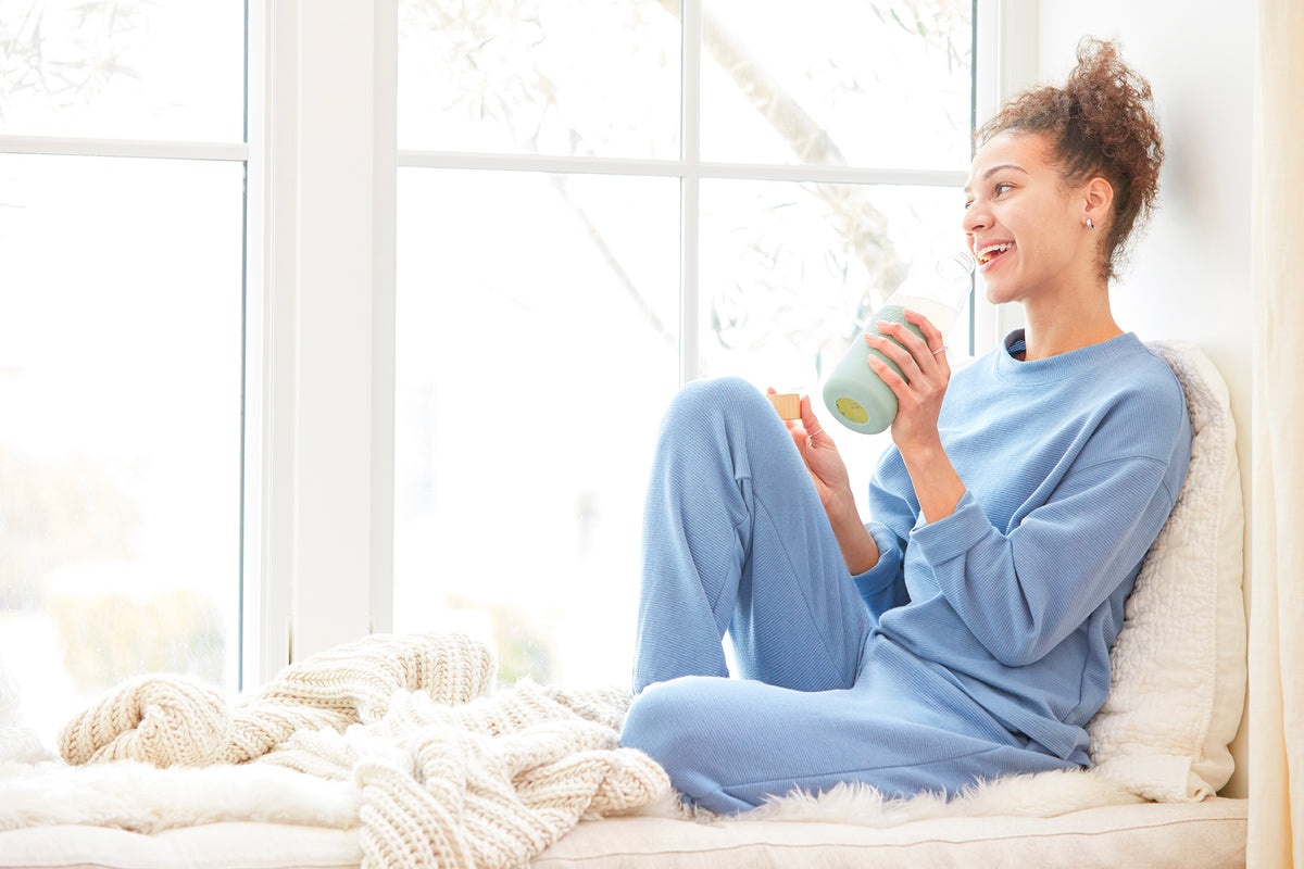 woman sitting next to window