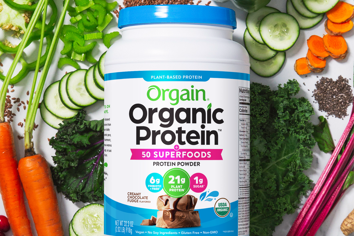 Orgain Organic Protein powder surrounded by fresh vegetables and superfoods, highlighting 21g protein and 1g sugar.