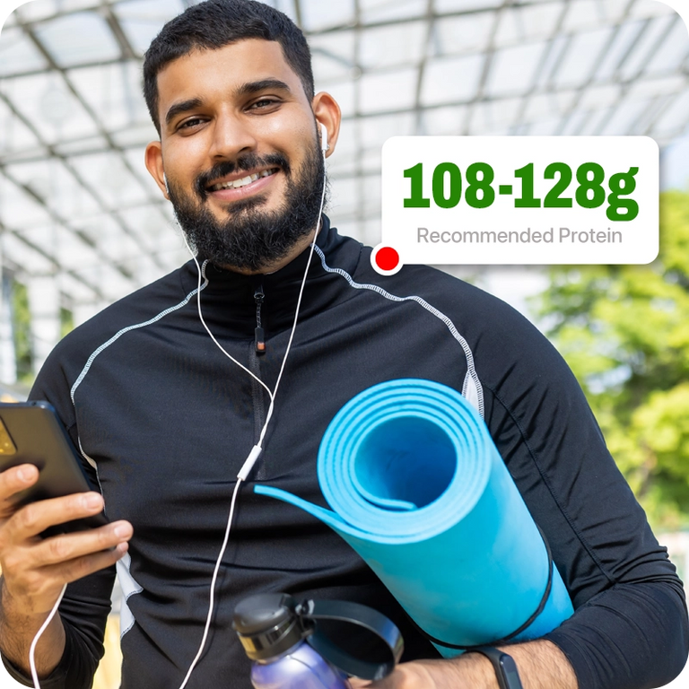 Man holding a blue yoga mat and smartphone with a green text box displaying protein information.