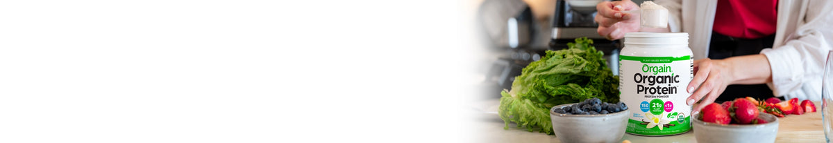 Person holding a container of Organic Valley yogurt with a kitchen background