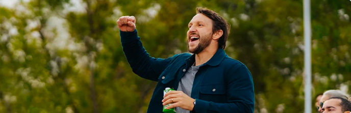 man raising his hand at a public event